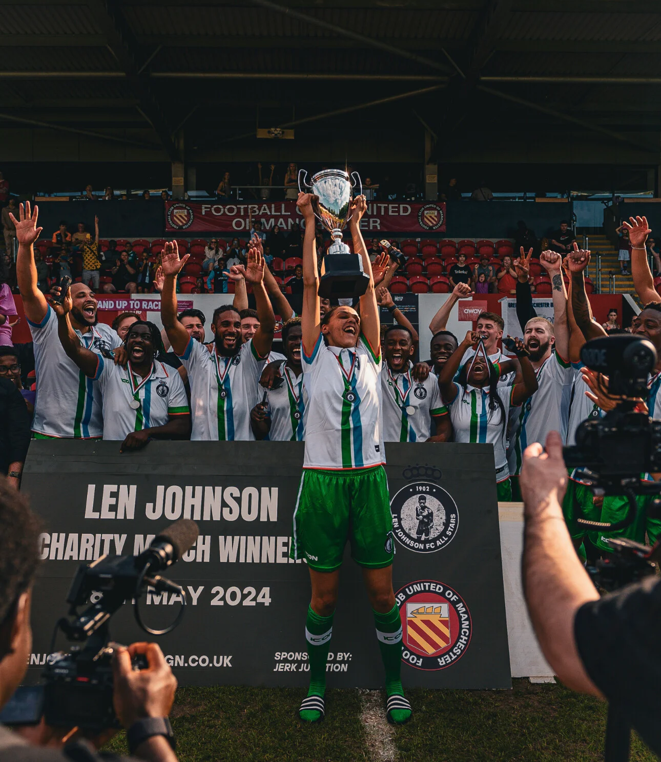 Lifting the trophy at the charity match